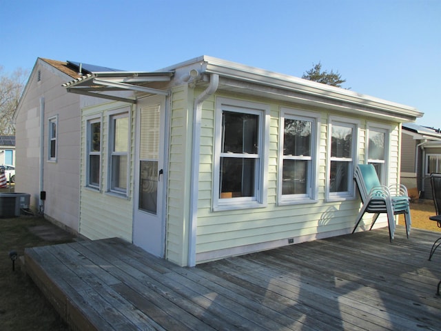 view of side of home featuring cooling unit and a deck