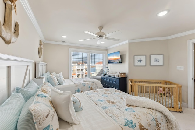 carpeted bedroom featuring crown molding, visible vents, and ceiling fan