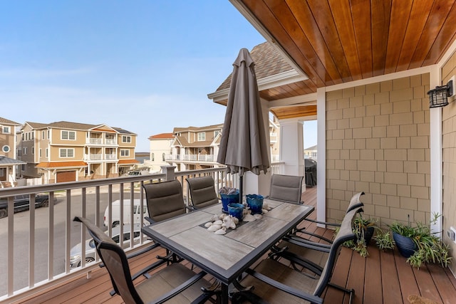 deck with grilling area, a residential view, and outdoor dining space