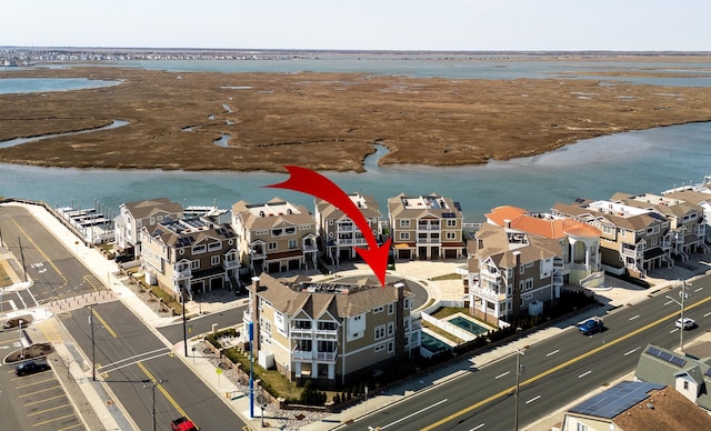 birds eye view of property featuring a water view and a residential view