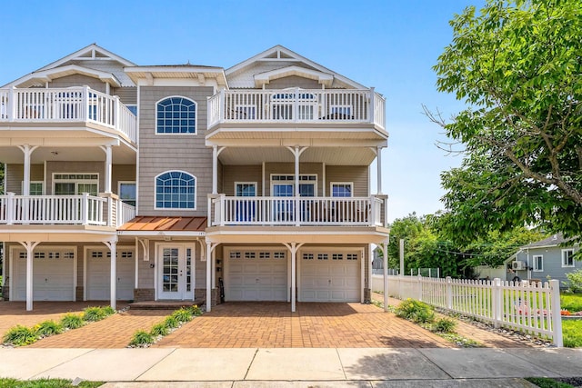 145 W Andrews Ave Unit 100, Wildwood, NJ 08260 - view of front of house with a balcony, a garage, decorative driveway, and french doors