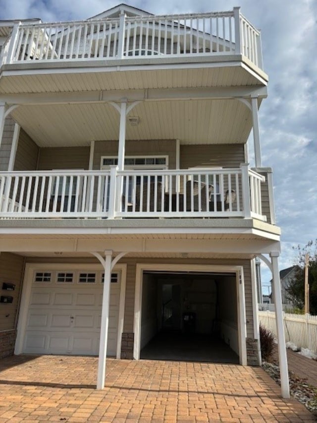 145 W Andrews Ave Unit 100, Wildwood, NJ 08260 - view of property exterior featuring a balcony, a garage, and decorative driveway