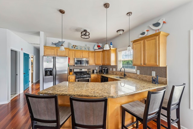145 W Andrews Ave Unit 100, Wildwood, NJ 08260 - kitchen with stainless steel appliances, a peninsula, backsplash, light stone counters, and dark wood finished floors