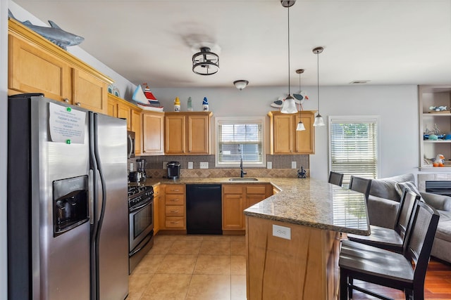 145 W Andrews Ave Unit 100, Wildwood, NJ 08260 - kitchen featuring stainless steel appliances, a peninsula, plenty of natural light, and decorative backsplash