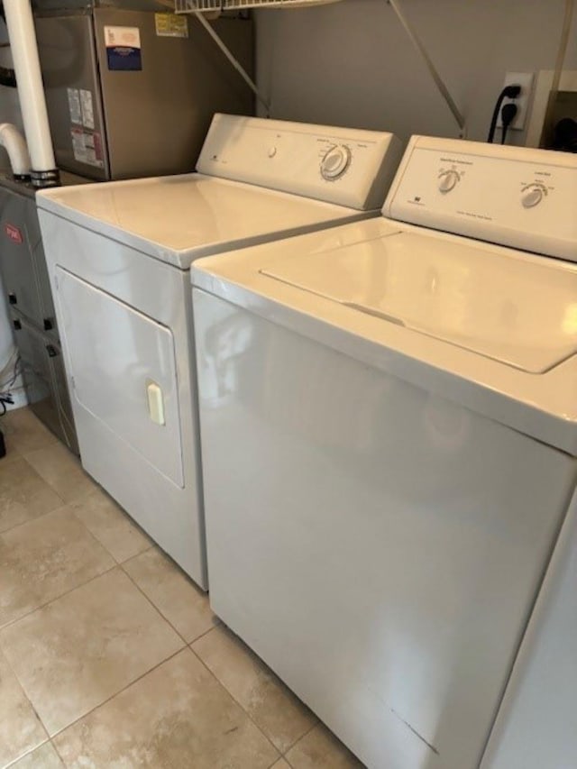 145 W Andrews Ave Unit 100, Wildwood, NJ 08260 - laundry room with washer and dryer and light tile patterned flooring