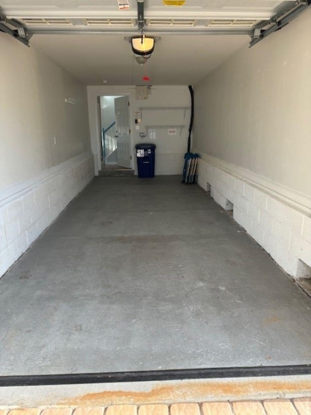 145 W Andrews Ave Unit 100, Wildwood, NJ 08260 - garage featuring a garage door opener and concrete block wall