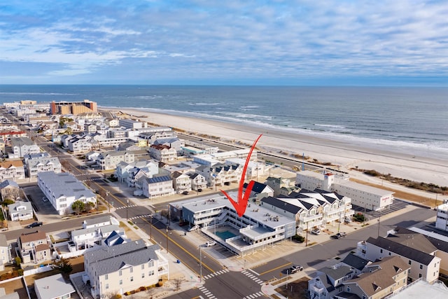 drone / aerial view featuring a water view and a beach view