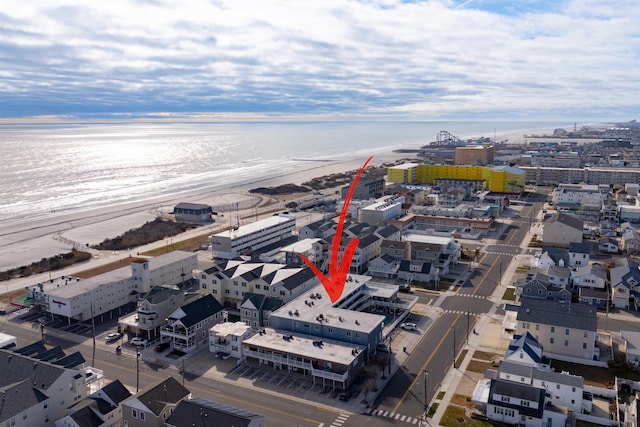 birds eye view of property featuring a view of the beach and a water view