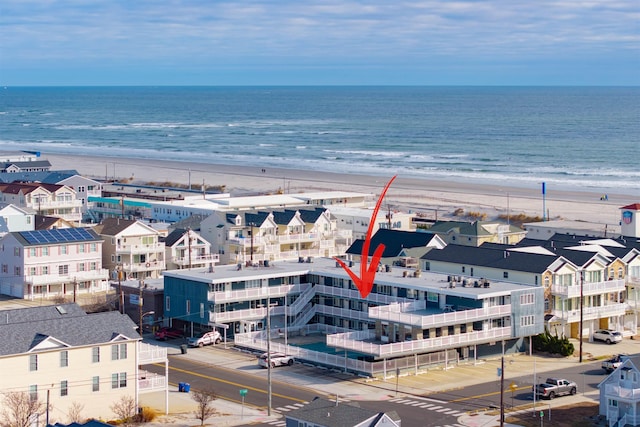 birds eye view of property with a beach view and a water view