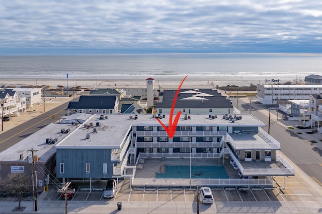 bird's eye view featuring a water view and a view of the beach