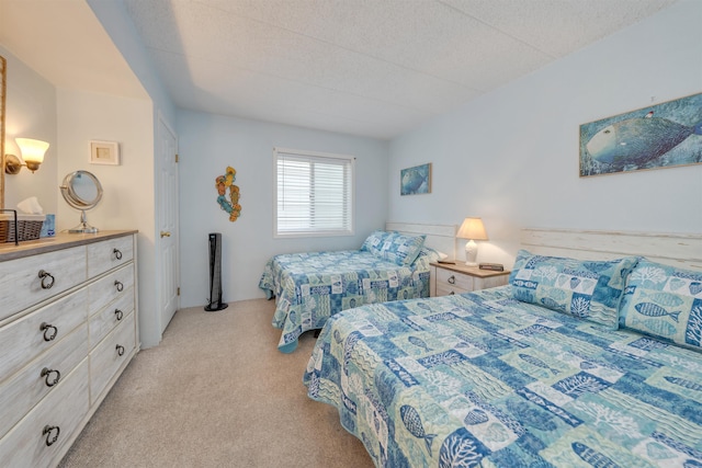 carpeted bedroom featuring a textured ceiling