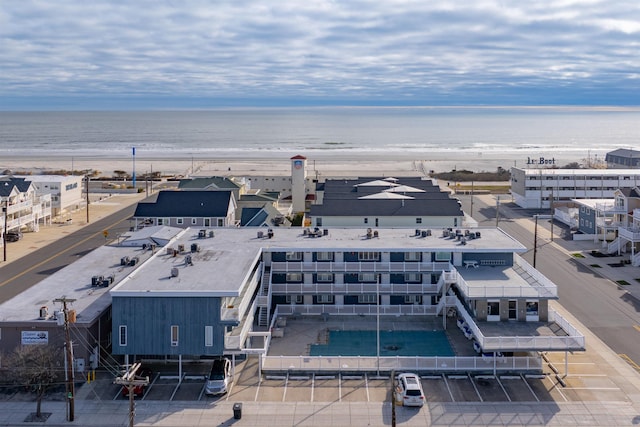 drone / aerial view featuring a water view and a beach view