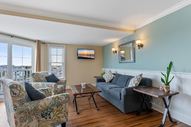 living room with hardwood / wood-style flooring and ornamental molding