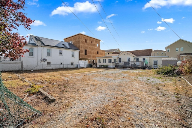 rear view of property with solar panels