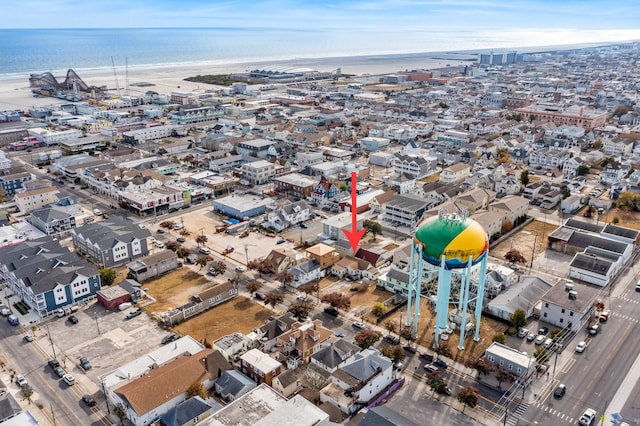 drone / aerial view with a water view and a beach view