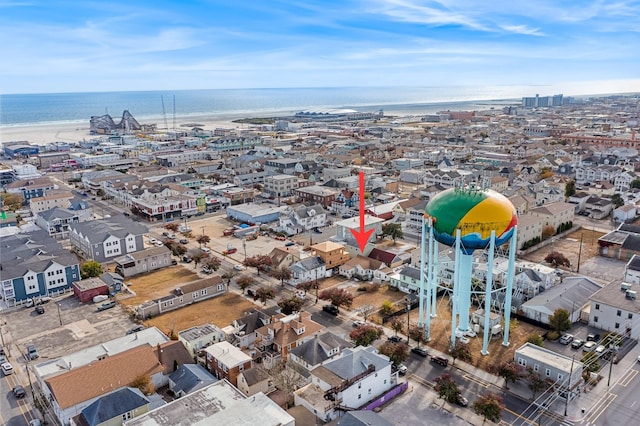 drone / aerial view featuring a water view and a beach view