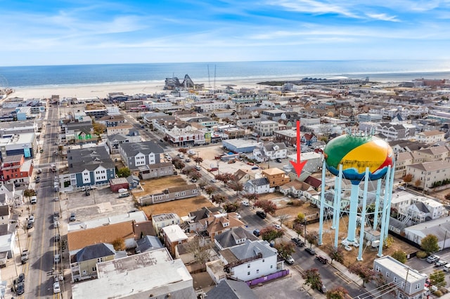 birds eye view of property featuring a water view and a beach view