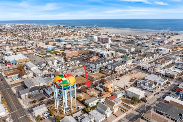 drone / aerial view with a water view and a beach view