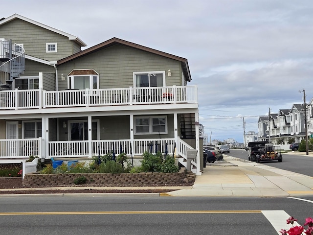 view of front of home with a porch and a balcony