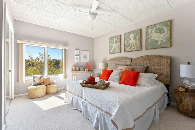 carpeted bedroom with baseboards and a ceiling fan