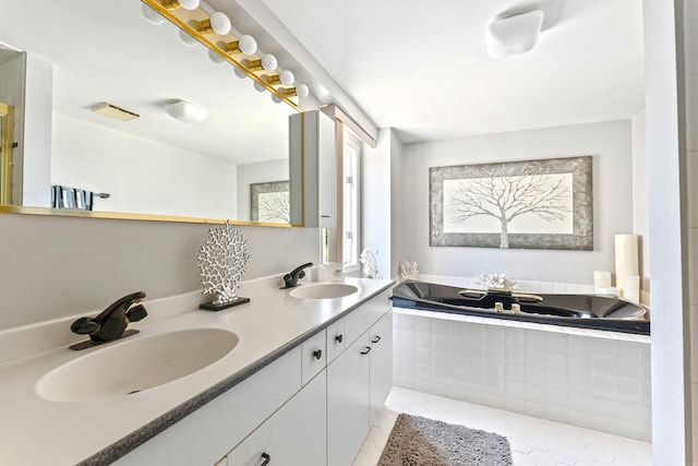 full bath with tile patterned flooring, double vanity, a sink, and a bath