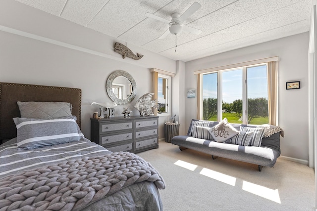 bedroom with a ceiling fan, baseboards, carpet flooring, and radiator heating unit