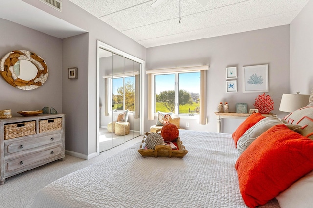 bedroom featuring access to exterior, carpet, visible vents, and baseboards