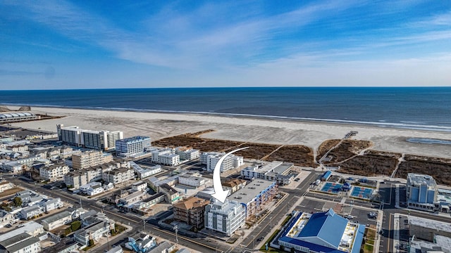 bird's eye view featuring a view of the beach and a water view