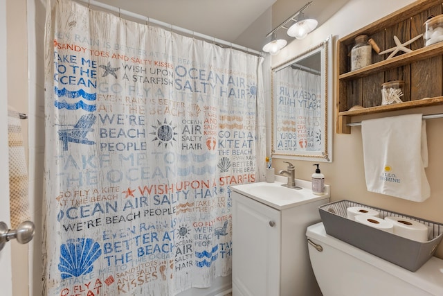 bathroom featuring curtained shower, toilet, and vanity