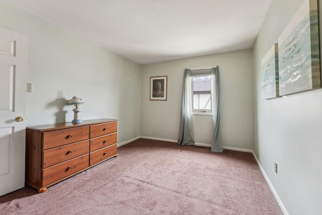 unfurnished bedroom featuring carpet flooring and baseboards