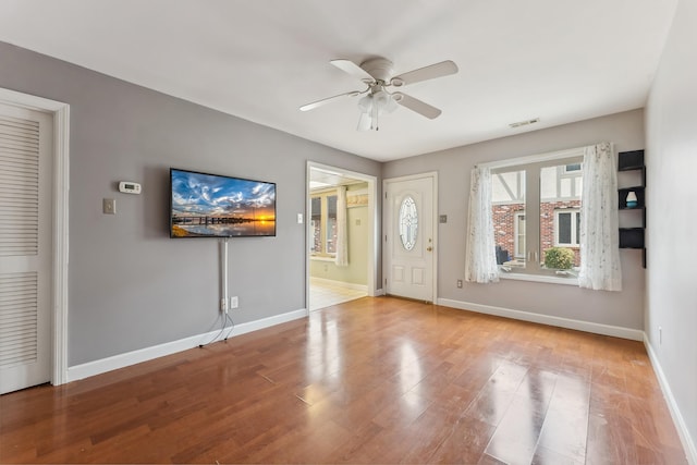 entryway with ceiling fan, baseboards, and wood finished floors