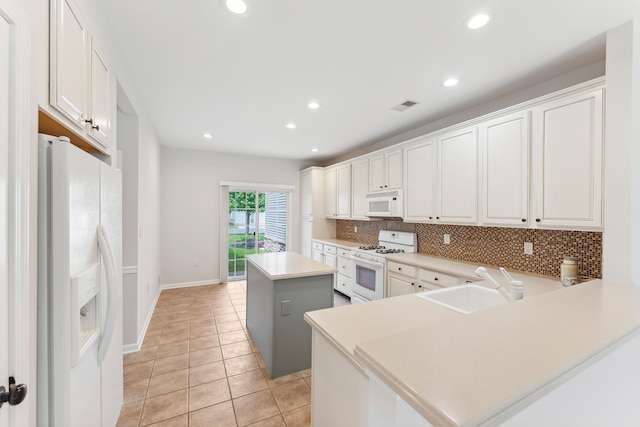 201 Saint Andrews Dr Unit 201, Swainton, NJ 08210 - kitchen with white appliances, a center island, a sink, tasteful backsplash, and recessed lighting
