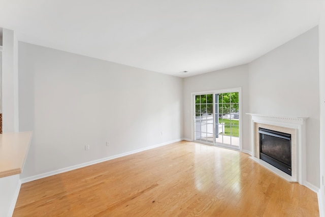 201 Saint Andrews Dr Unit 201, Swainton, NJ 08210 - unfurnished living room featuring light wood-style floors, a premium fireplace, and baseboards