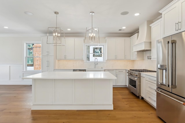 427 E 5th Ave, North Wildwood, NJ 08260 - kitchen featuring high quality appliances, custom range hood, a kitchen island, light countertops, and white cabinetry