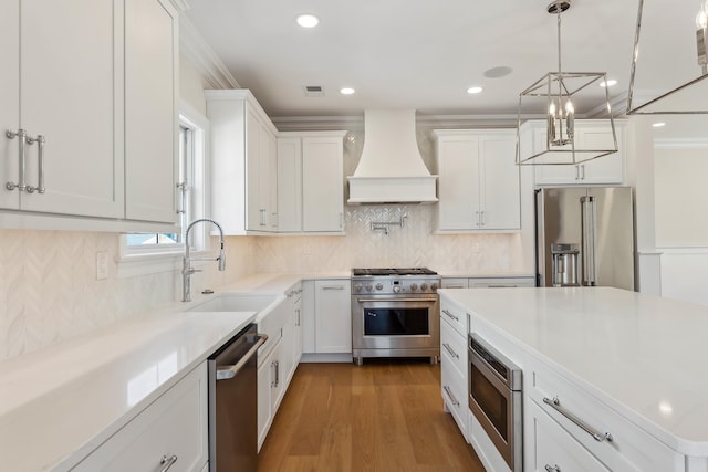 427 E 5th Ave, North Wildwood, NJ 08260 - kitchen featuring high end appliances, custom range hood, white cabinetry, a chandelier, and tasteful backsplash