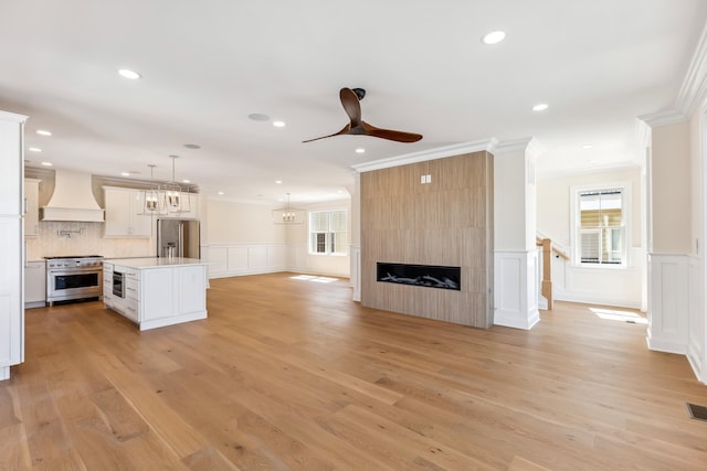 427 E 5th Ave, North Wildwood, NJ 08260 - unfurnished living room with ceiling fan, ornamental molding, a decorative wall, light wood-type flooring, and recessed lighting