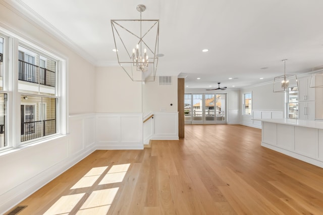 427 E 5th Ave, North Wildwood, NJ 08260 - unfurnished dining area featuring a decorative wall, a chandelier, ornamental molding, light wood-style flooring, and a wainscoted wall