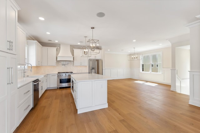427 E 5th Ave, North Wildwood, NJ 08260 - kitchen with custom range hood, premium appliances, a chandelier, light countertops, and a kitchen island