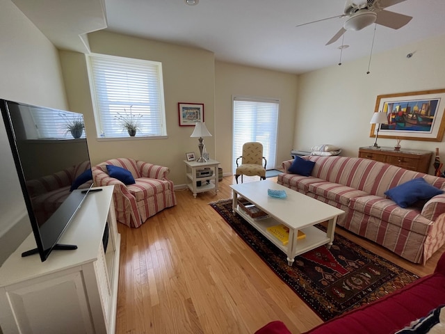 living room with ceiling fan and light hardwood / wood-style floors