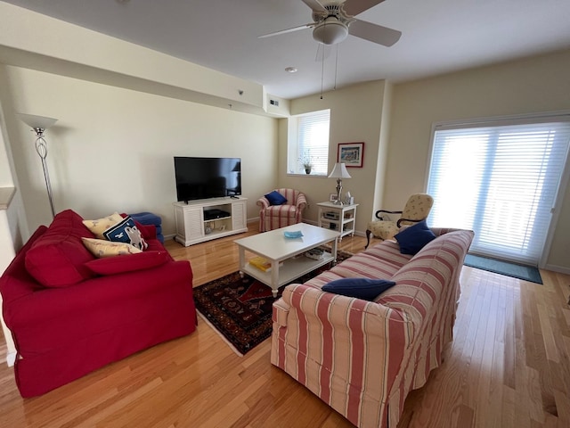 living room featuring ceiling fan and light hardwood / wood-style flooring