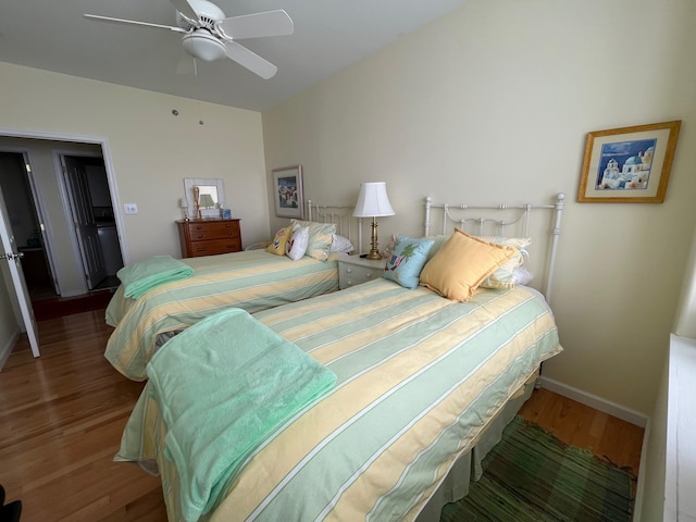 bedroom with ceiling fan and hardwood / wood-style flooring