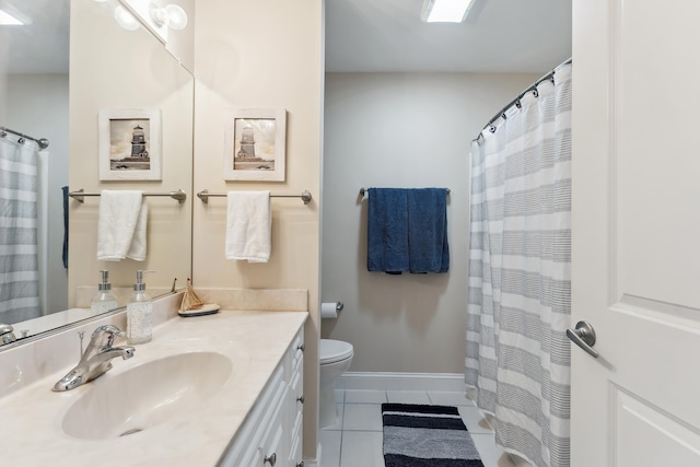 bathroom with tile patterned floors, vanity, and toilet