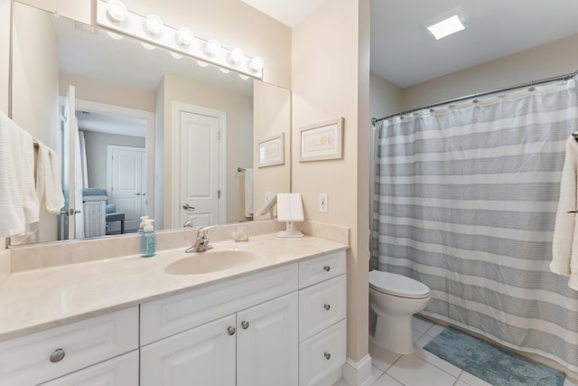 bathroom featuring tile patterned floors, vanity, and toilet