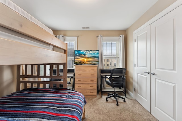 carpeted bedroom featuring a closet