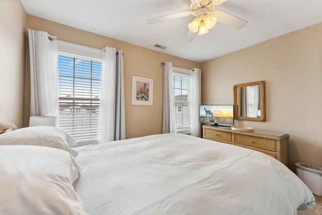 bedroom with multiple windows and ceiling fan