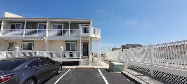 view of building exterior with uncovered parking