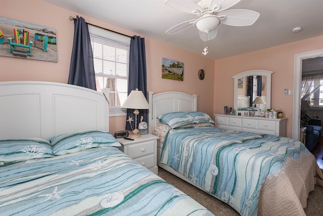 carpeted bedroom with ceiling fan and multiple windows