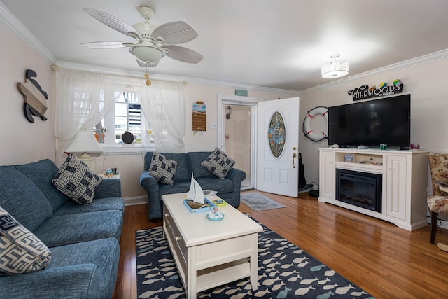 living room featuring ceiling fan, crown molding, and dark hardwood / wood-style floors