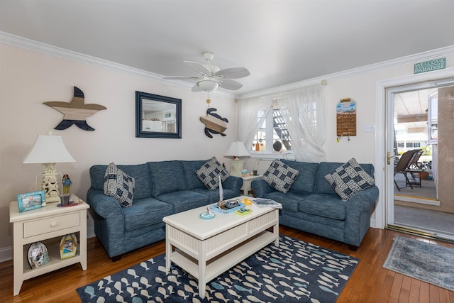 living room with dark hardwood / wood-style floors, ceiling fan, and crown molding