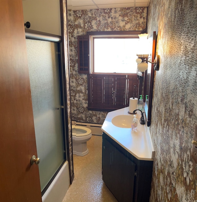 full bath with vanity, toilet, a drop ceiling, wallpapered walls, and baseboard heating